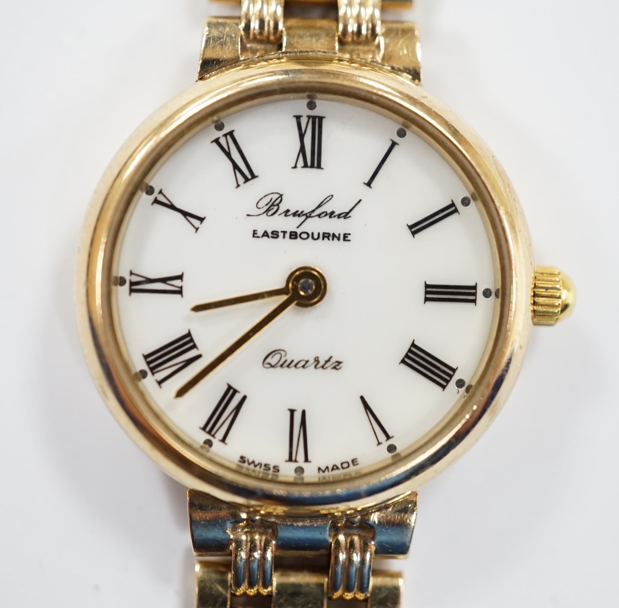 A lady's modern 9ct gold quartz bracelet wrist watch, retailed by Brufords, overall 17.7cm, gross weight 23.1 grams.
